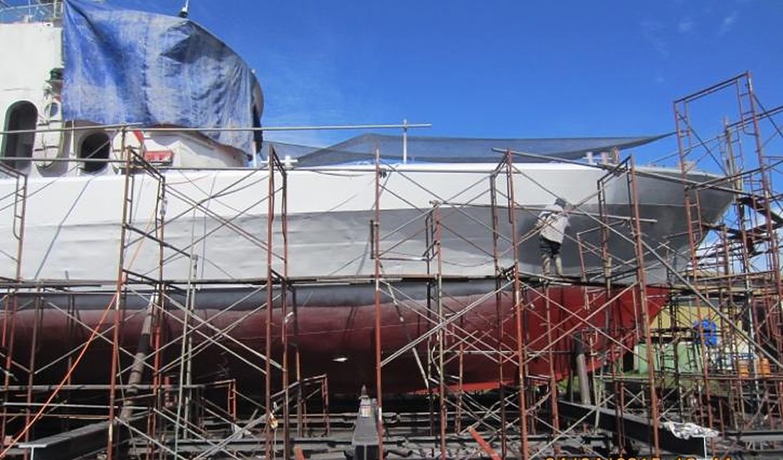 Vessel hull under repair inside scaffolding at the Bintawa shipyard