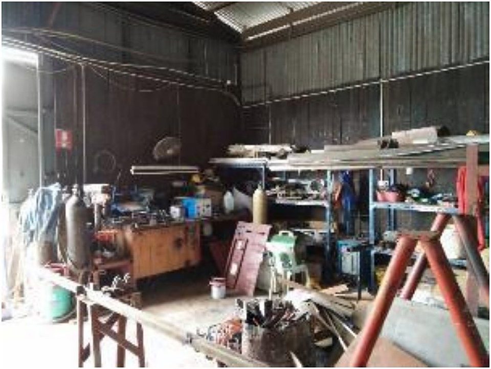 Fabrication workshop interior with machinery and welding equipment