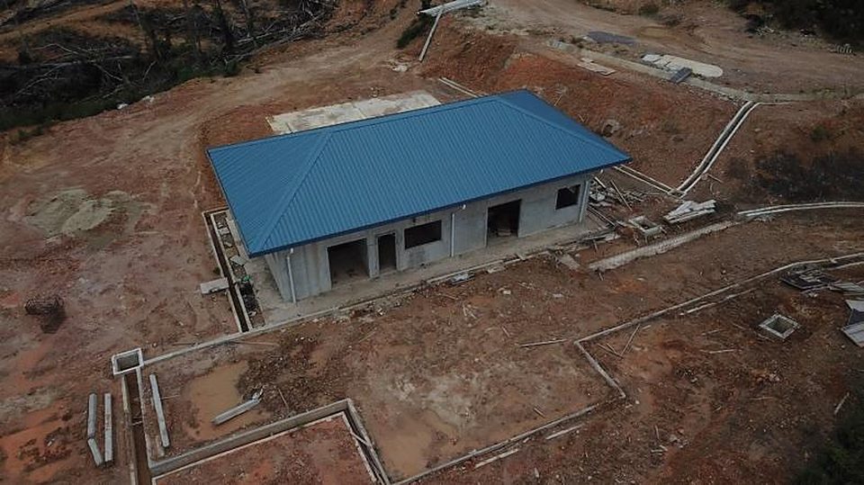 Pump house building with blue roof on a prepared platform