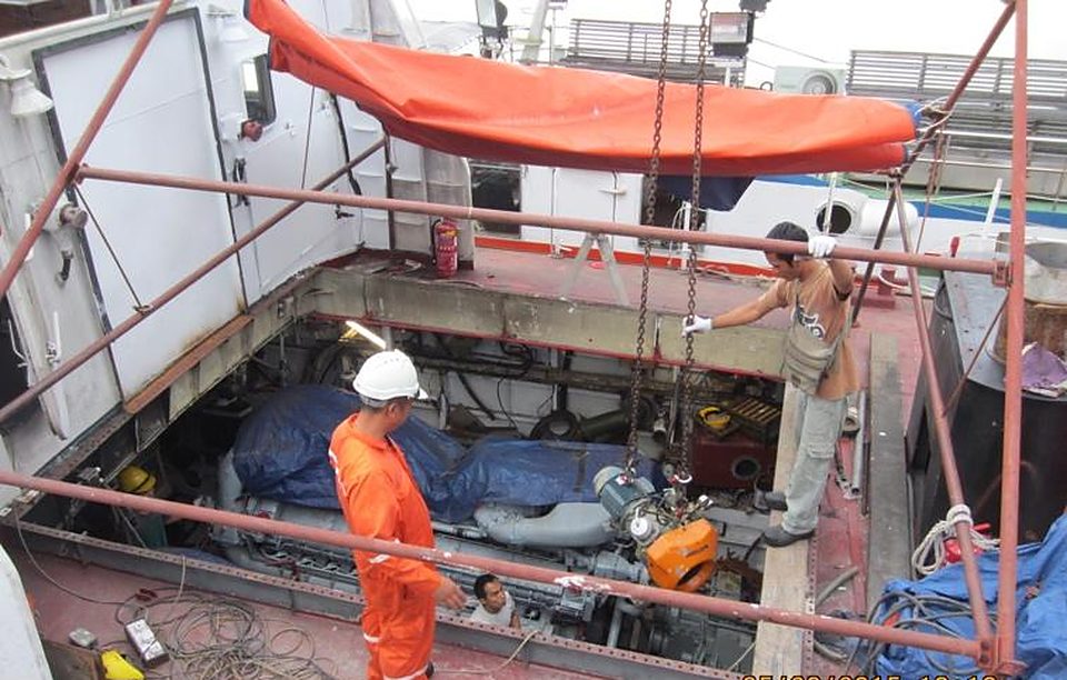 Shipyard crew working on the deck of a vessel under repair